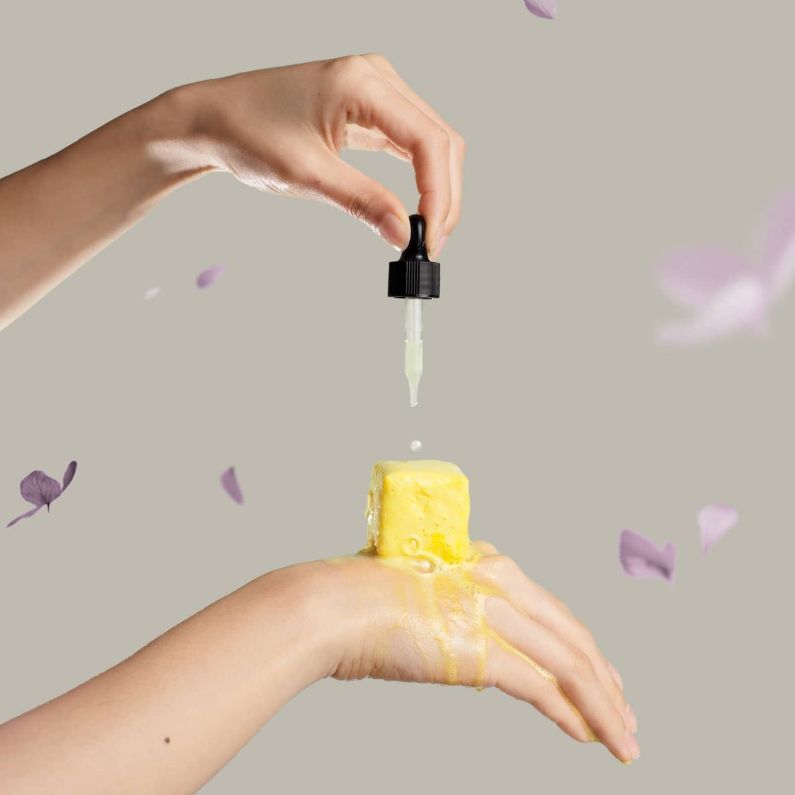 Hand squeezing essential oil onto yellow shower steamer in Australia